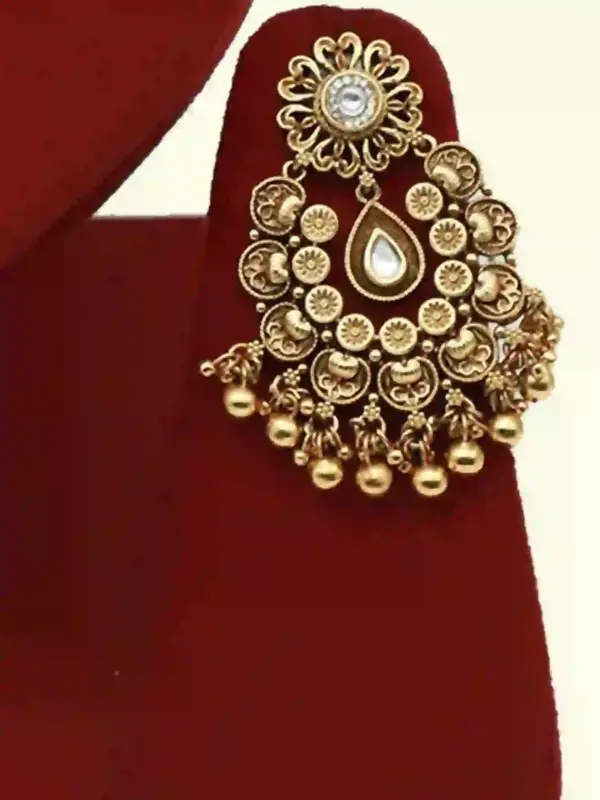 Antique gold brass bridal necklace set with Kundan stones, matching earrings, and maangtika on red display, Ishwar Arts and Crafts