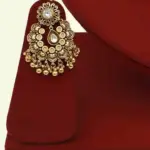 Antique gold brass bridal necklace set with Kundan stones, matching earrings, and maangtika on red display, Ishwar Arts and Crafts